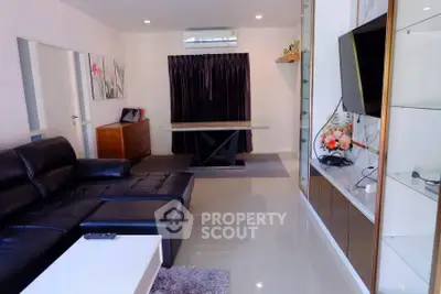 Modern living room with sleek leather sofa and wall-mounted TV