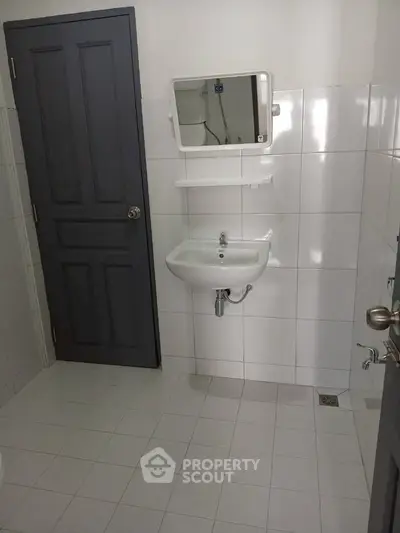 Modern bathroom with sleek white tiles and minimalist fixtures
