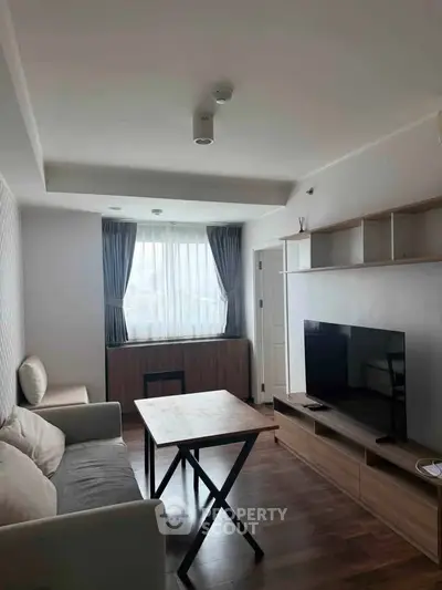 Modern living room with sleek furniture and natural light, perfect for cozy relaxation.