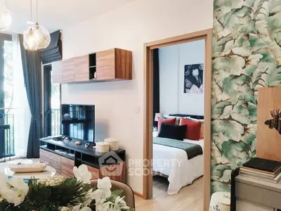 Modern open-plan living room with stylish decor and view into cozy bedroom