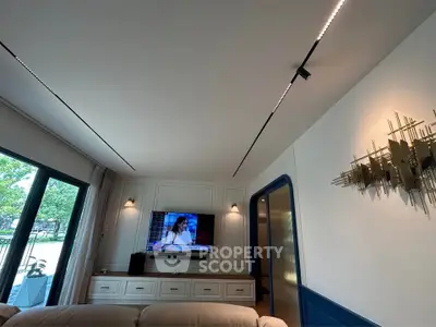 Modern living room with sleek lighting and large window view