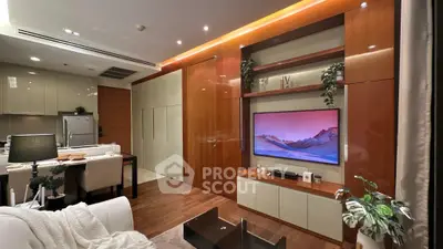 Luxurious modern living room with open kitchen, sleek cabinetry, and stylish decor in a contemporary apartment.