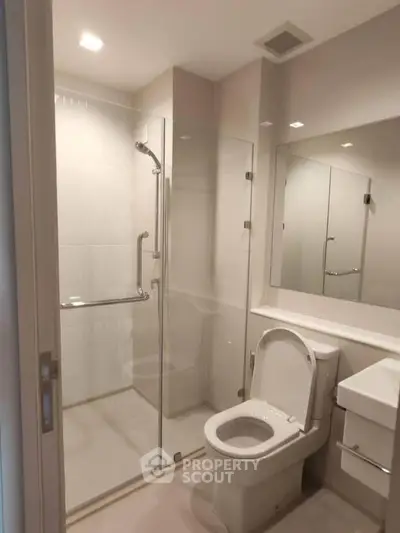 Modern bathroom with glass shower enclosure and sleek fixtures