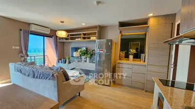Modern living room with open kitchen, stylish decor, and balcony view