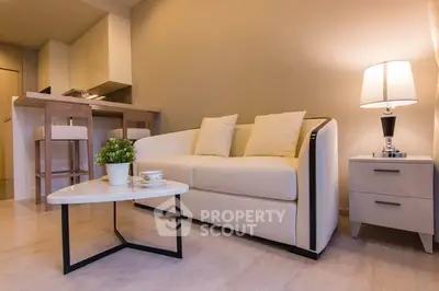 Modern living room with cozy sofa, stylish coffee table, and elegant lighting in a chic apartment.