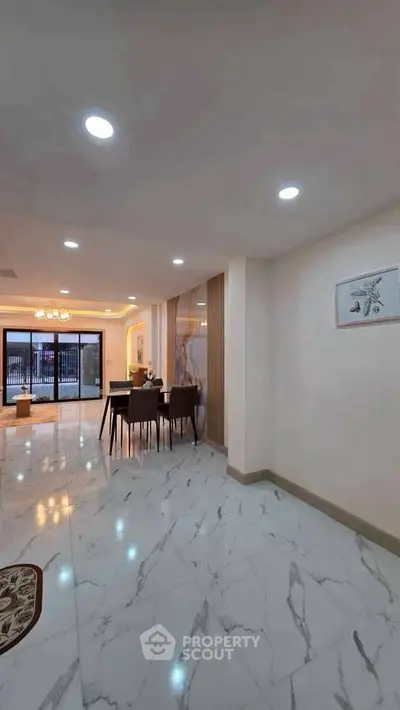 Spacious modern living room with elegant marble flooring and stylish dining area.