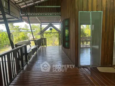 Charming wooden exterior with spacious balcony and lush garden view, perfect for serene living.