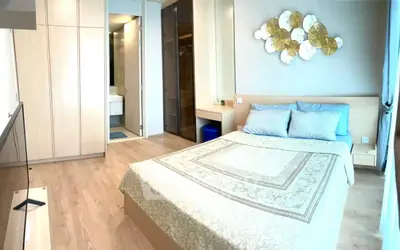 Spacious bedroom with elegant decor and ample natural light