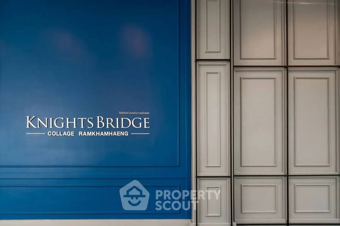 Elegant Knightsbridge Collage Ramkhamhaeng entrance with stylish blue and gray paneling.