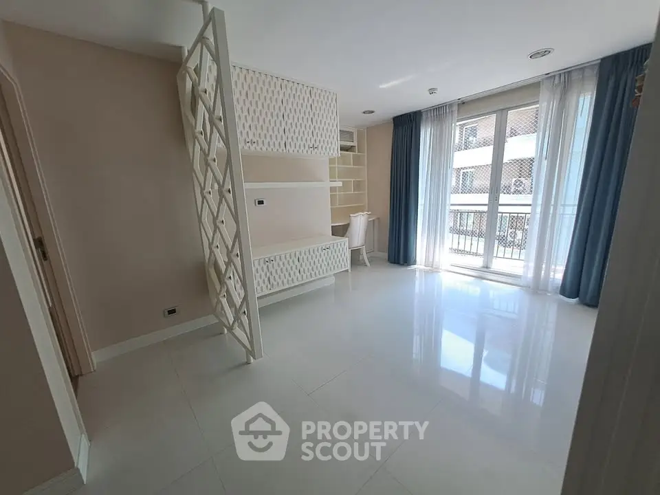 Spacious modern living room with elegant partition and large windows for natural light.