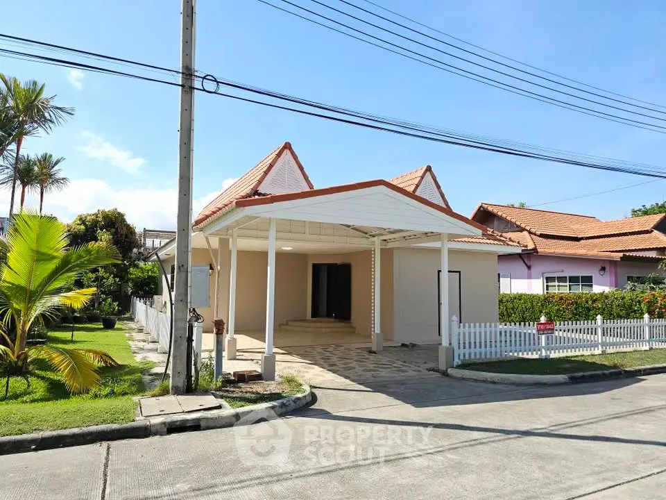 Charming single-story house with tiled roof and spacious driveway in a serene neighborhood.