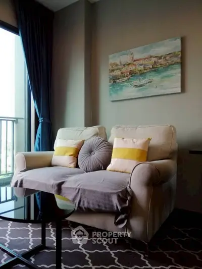 Cozy living room with elegant sofa and artistic wall painting, perfect for relaxation and style.