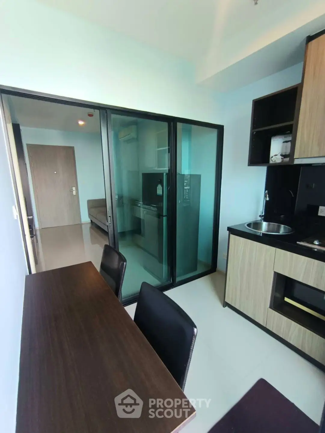 Modern kitchen with sleek design and glass partition in stylish apartment