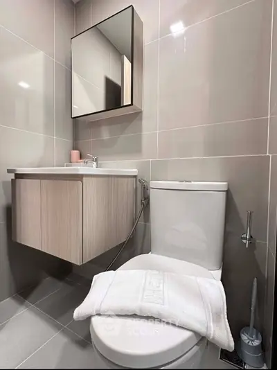 Modern bathroom with sleek fixtures and wall-mounted vanity in a stylish apartment.