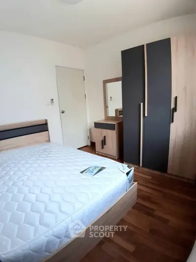 Modern bedroom with stylish wardrobe and cozy wooden flooring