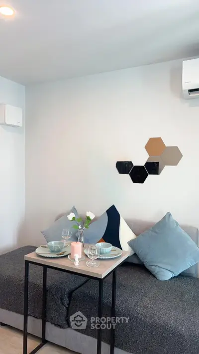 Cozy living room with modern decor and dining setup, perfect for urban living.