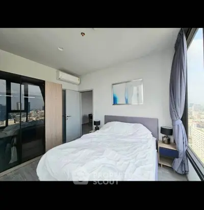 Spacious bedroom with panoramic city view and modern decor