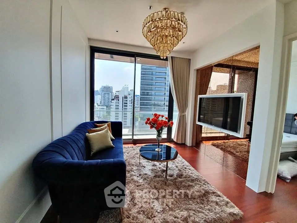 Luxurious living room with elegant chandelier and city view balcony