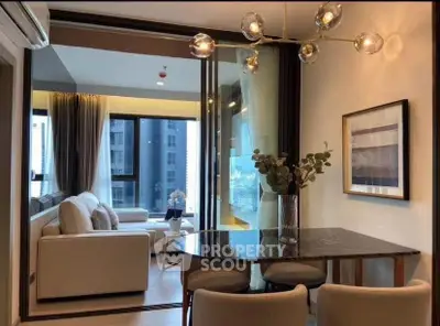 Modern living room with elegant dining area and large windows in a stylish apartment.
