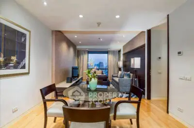 Elegant living room with modern decor and city view, featuring a stylish dining area.