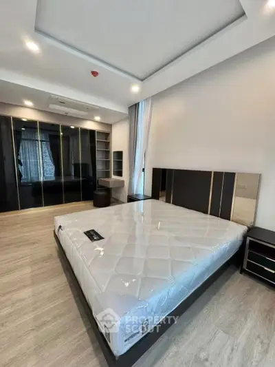 Spacious modern bedroom with sleek design and ample storage space