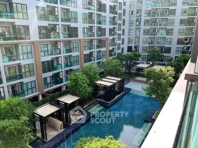 Luxurious apartment complex with stunning pool and lush greenery view