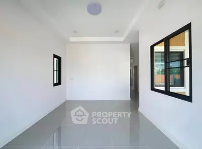 Spacious modern room with large windows and glossy tiled floor