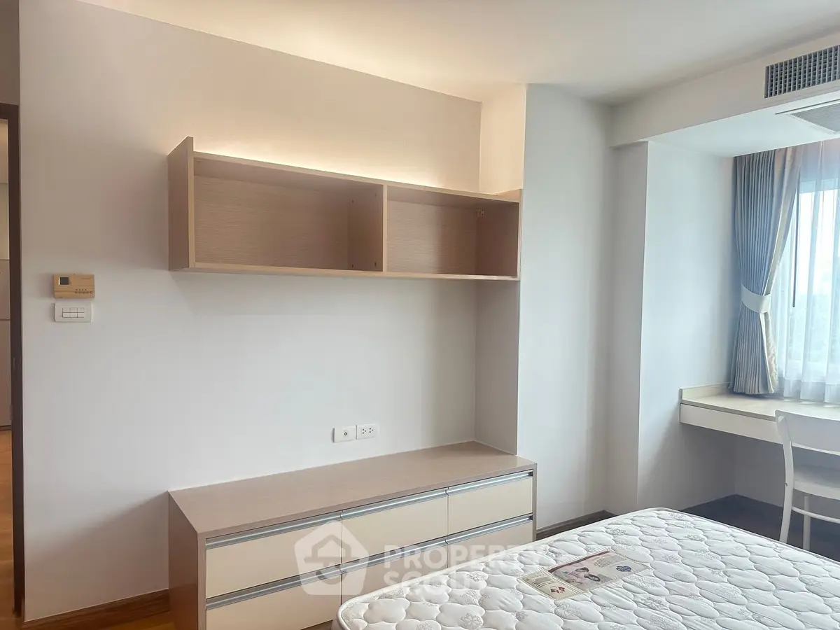 Bright and airy bedroom with modern furniture and large window view