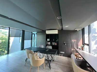 Modern study room with sleek design and large windows offering natural light.