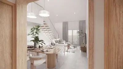Modern open-plan living room with stylish decor and staircase in a bright, airy space.