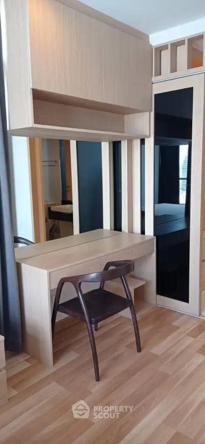 Modern study area with sleek wooden desk and chair, perfect for productivity in a stylish home.