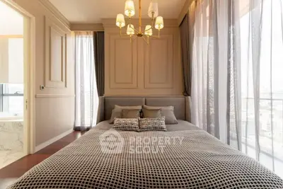 Luxurious bedroom with elegant decor and large windows offering abundant natural light
