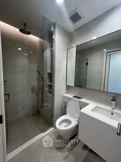 Modern bathroom with glass shower and sleek fixtures
