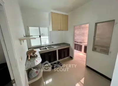 Compact kitchen with modern cabinetry and ample natural light