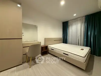 Modern bedroom with minimalist design, featuring a comfortable bed and stylish furniture.