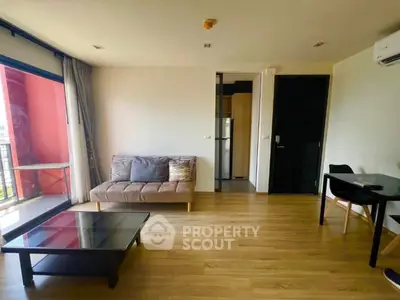 Modern living room with wooden flooring and balcony access