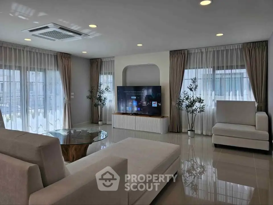 Spacious modern living room with elegant decor and large windows