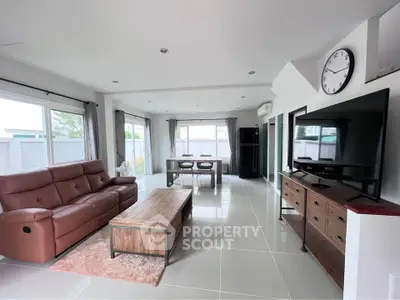 Spacious modern living room with large windows and stylish furniture