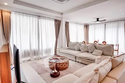 Spacious modern living room with elegant decor and ample natural light