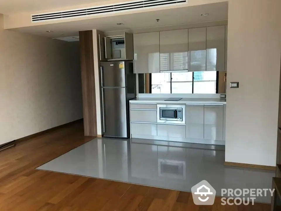 Spacious kitchen with modern appliances and ample natural light, featuring a sleek design and a practical layout in a high-end property.