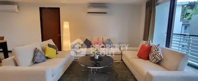 Spacious modern living room with stylish sofas and large windows