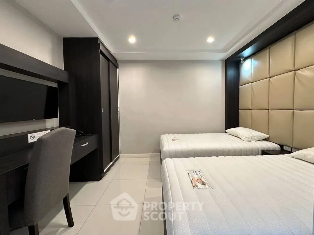 Modern bedroom with twin beds and sleek furniture design