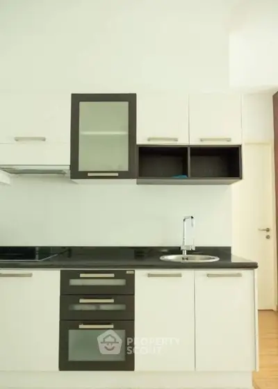 Modern kitchen with sleek cabinets and built-in oven