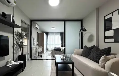 Modern living room with sleek design and cozy bedroom view