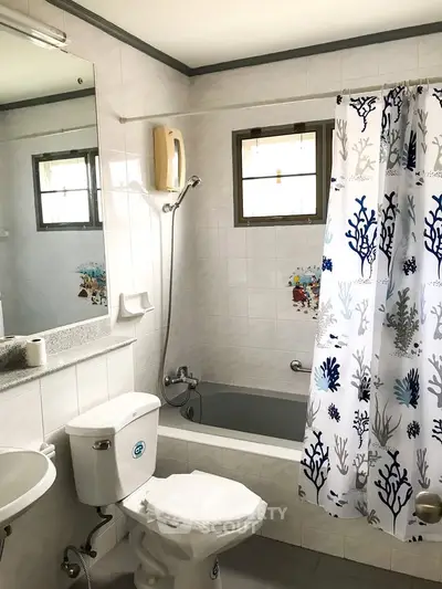 Charming bathroom with bathtub and ocean-themed shower curtain