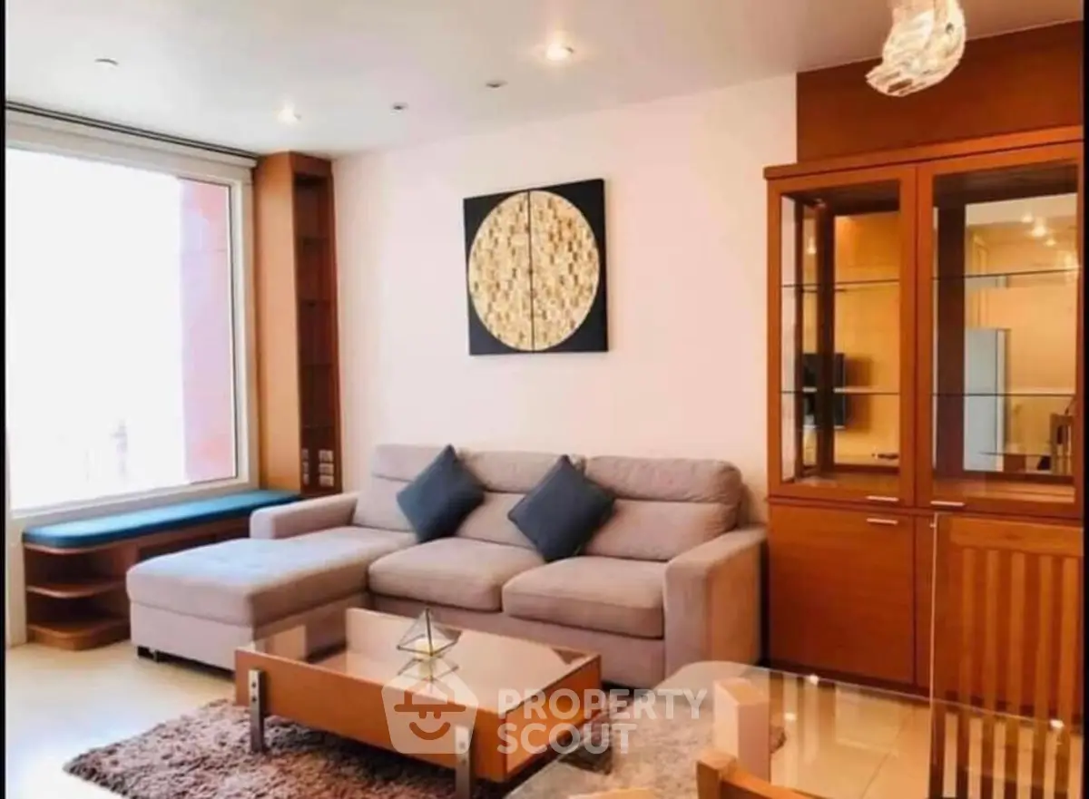 Stylish living room with modern furniture and large window for natural light.
