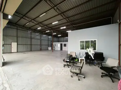 Spacious industrial warehouse with office space and high ceilings