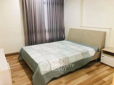Cozy bedroom with modern decor and wooden flooring, featuring a comfortable bed and elegant curtains.