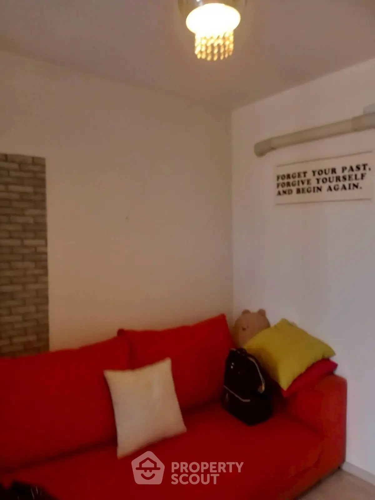 Cozy living room with red sofa and motivational wall art