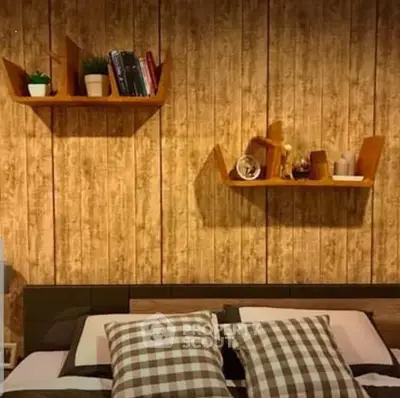 Cozy bedroom with stylish wooden wall shelves and checkered pillows for a warm ambiance.